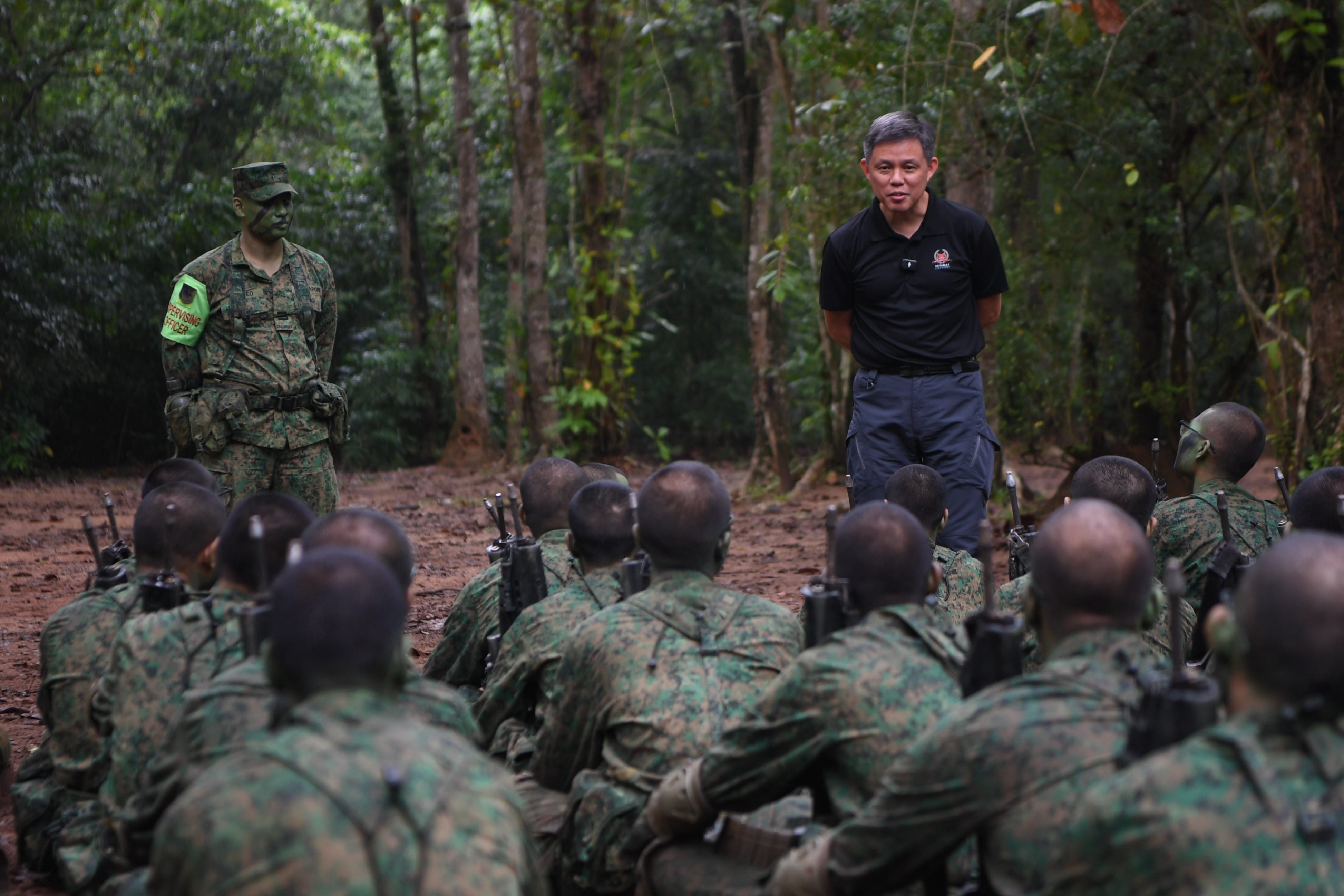 Minister for Defence Mr Chan Chun Sing interacting with recruits during their outfield training.